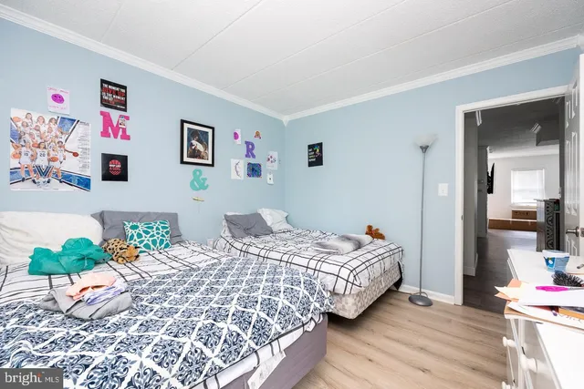 a bedroom with bed and a view of kitchen