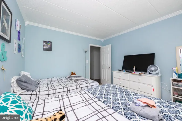 a bedroom with a bed and a television