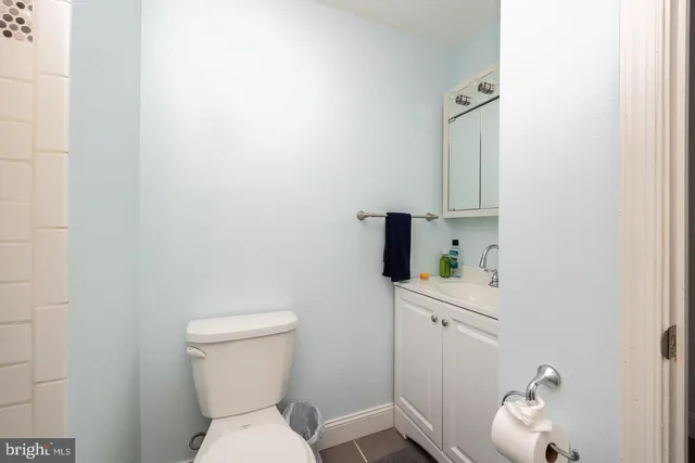 a white toilet sitting next to a bathroom sink
