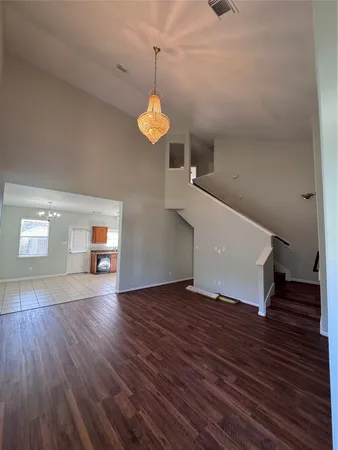 a view of a livingroom with wooden floor and a ceiling fan