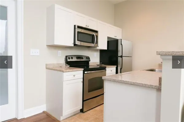 a kitchen with a refrigerator stove and microwave