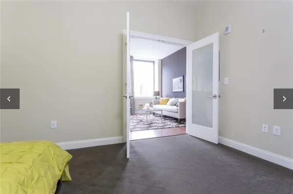 a view of a bedroom with a furniture and wooden floor