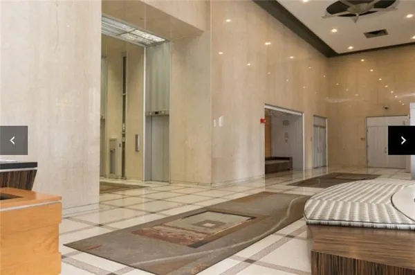 a spacious bedroom with a bed and a couch