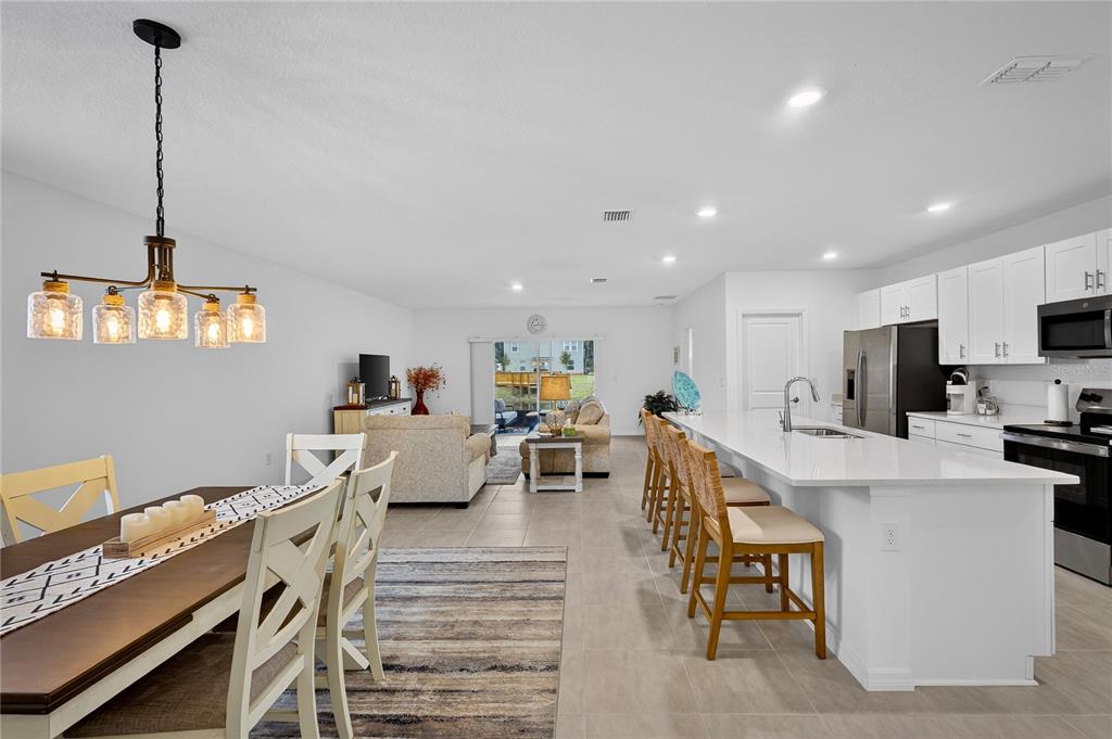 317 Riverfront Way Edgewater, FL 32141 - Photo 14 of 63 a living room with furniture a flat screen tv and a table