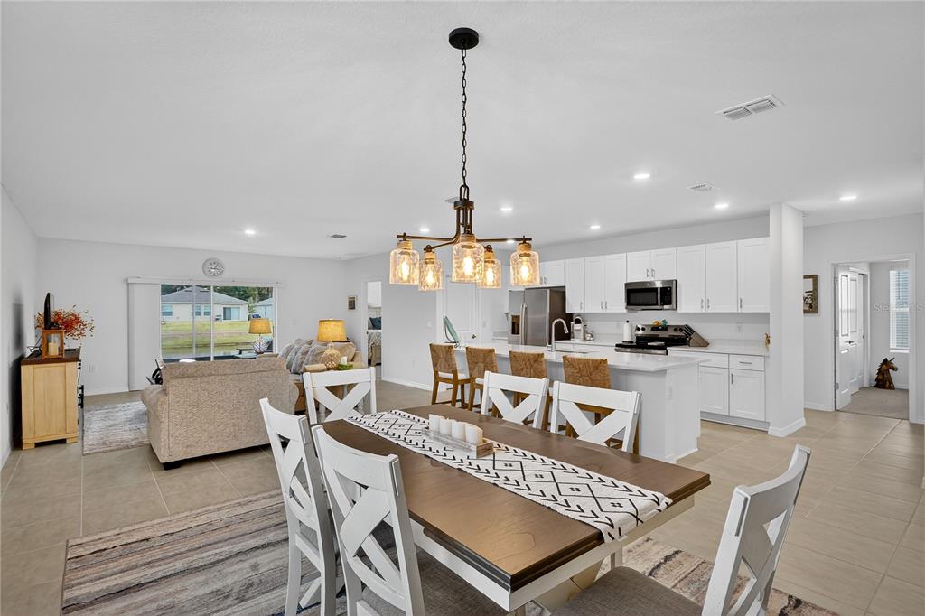 317 Riverfront Way Edgewater, FL 32141 - Photo 15 of 63 a large kitchen with a table and chairs