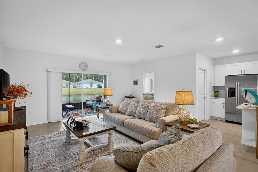 317 Riverfront Way Edgewater, FL 32141 - Photo 16 of 63 a living room with furniture a couch and a flat screen tv