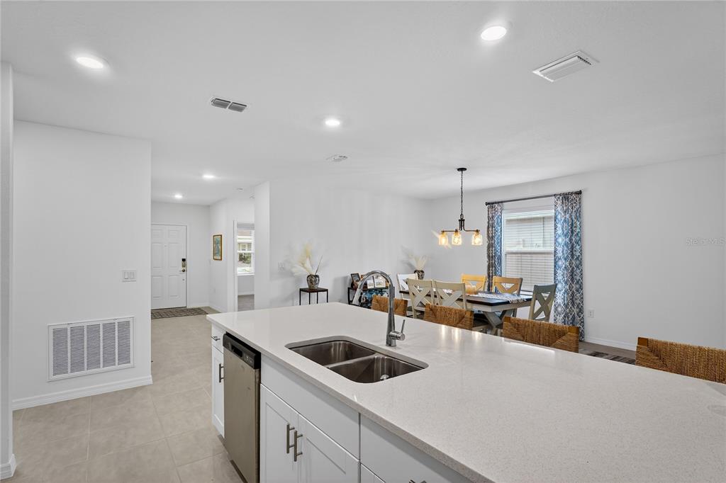 317 Riverfront Way Edgewater, FL 32141 - Photo 18 of 63 a kitchen with a sink a stove and cabinets