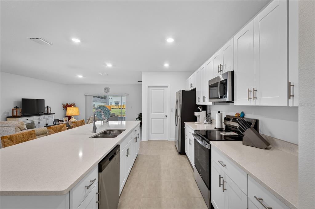 317 Riverfront Way Edgewater, FL 32141 - Photo 19 of 63 a kitchen with a sink a counter top space stainless steel appliances and cabinets