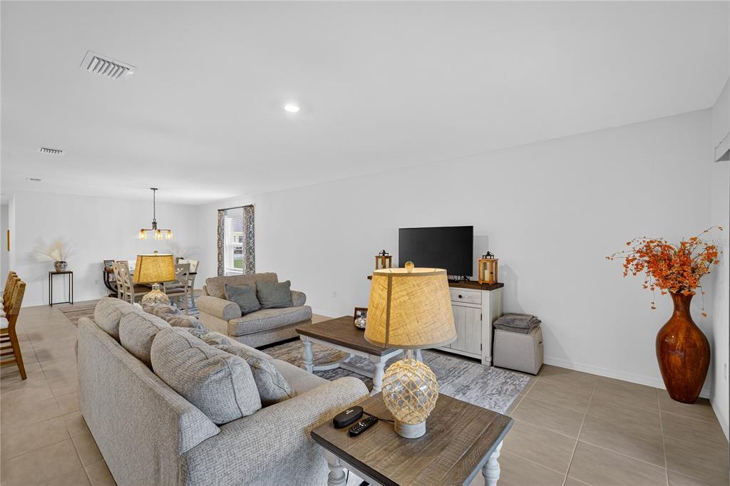 317 Riverfront Way Edgewater, FL 32141 - Photo 20 of 63 a living room with furniture and a flat screen tv