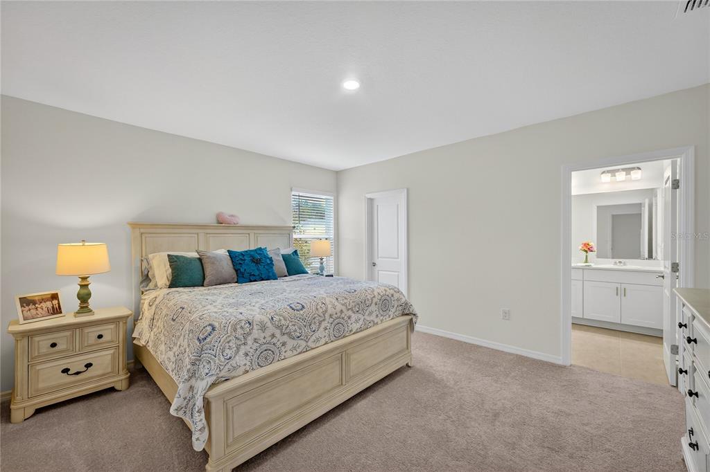 317 Riverfront Way Edgewater, FL 32141 - Photo 24 of 63 a bedroom with a bed and a lamp on dresser