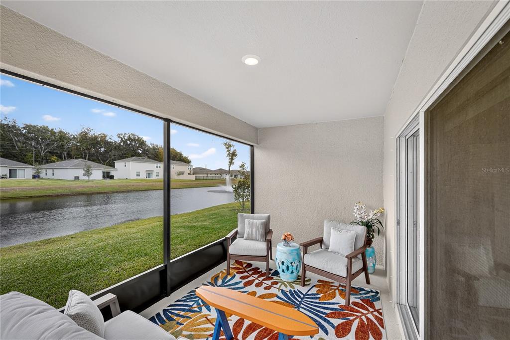 317 Riverfront Way Edgewater, FL 32141 - Photo 26 of 63 a balcony with furniture and a lake view
