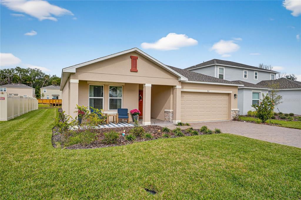 317 Riverfront Way Edgewater, FL 32141 - Photo 48 of 63 a front view of house with yard and green space