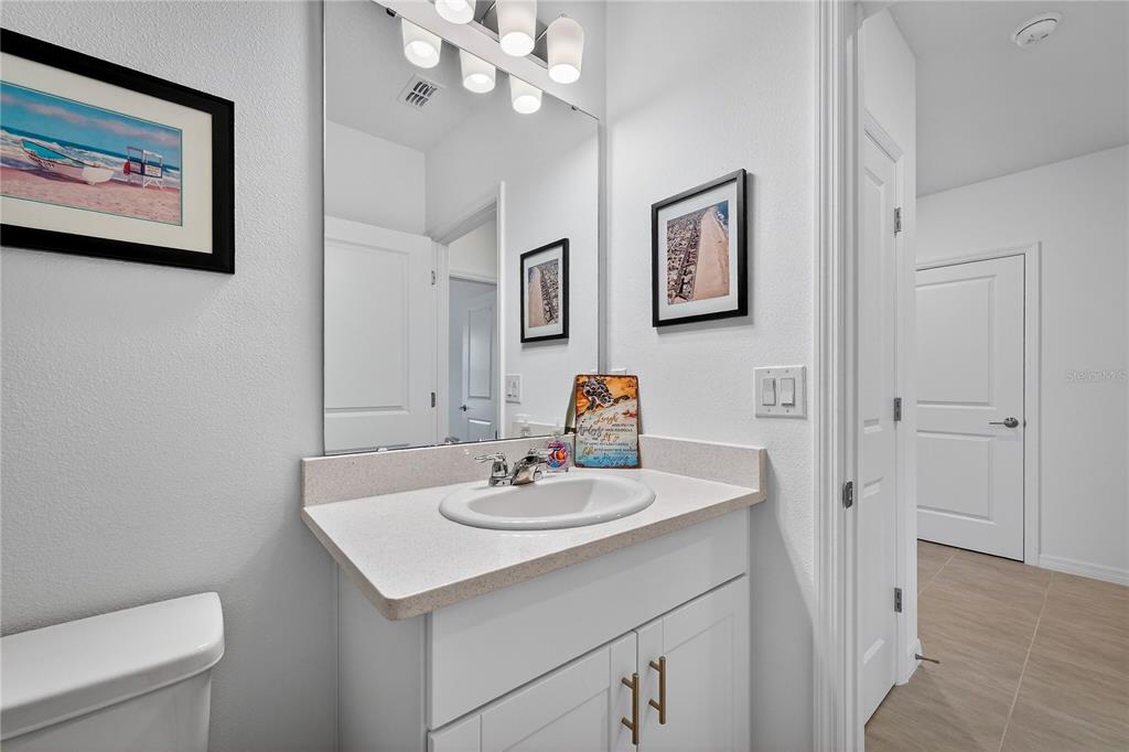 317 Riverfront Way Edgewater, FL 32141 - Photo 7 of 63 a bathroom with a sink a toilet and a mirror