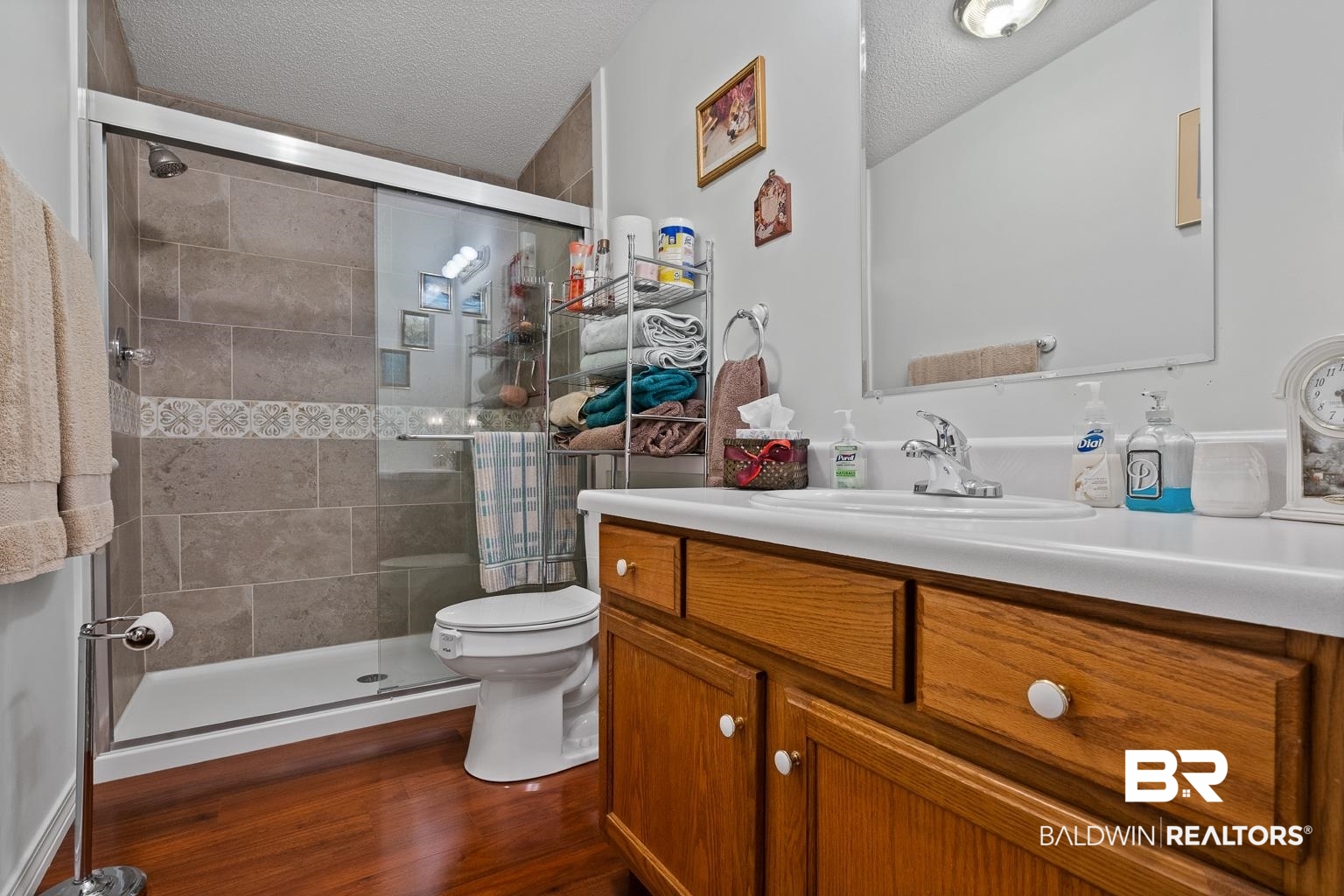 10647 Rte Road Lillian, AL 36549 - Photo 40 of 62 Bathroom with a textured ceiling, toilet, wood finished floors, and vanity
