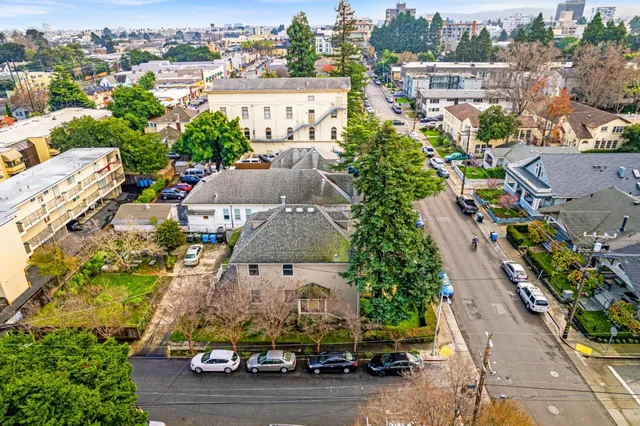 an aerial view of a house with a yard basket ball court and outdoor seating