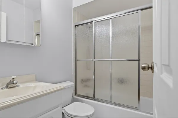 a bathroom with a toilet a sink and shower