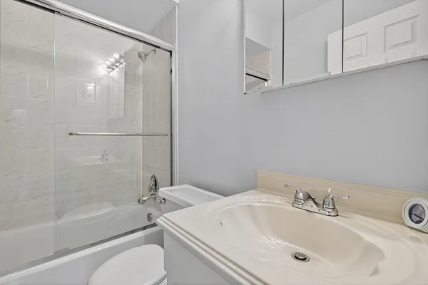 a bathroom with a sink toilet and shower