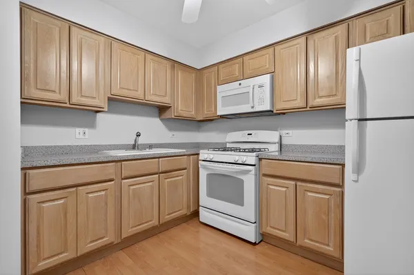 a kitchen with stainless steel appliances granite countertop a refrigerator sink and cabinets