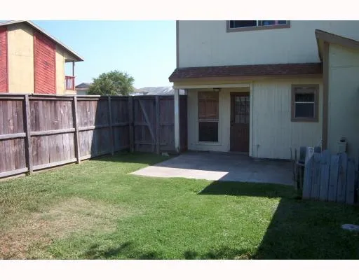 a view of backyard with seating area and green space