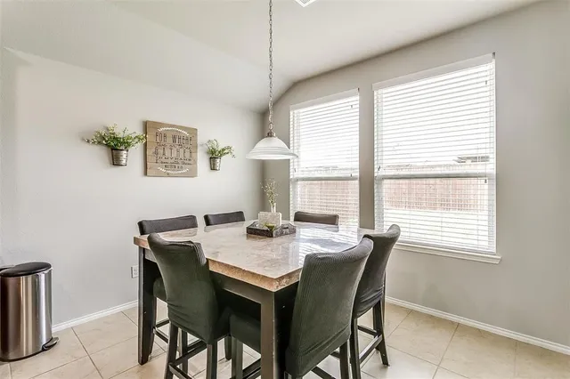a kitchen with a table and chairs in it