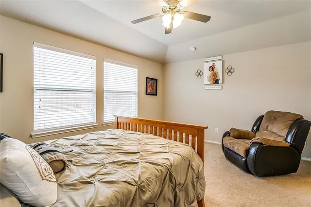 a bedroom with a bed and a chair