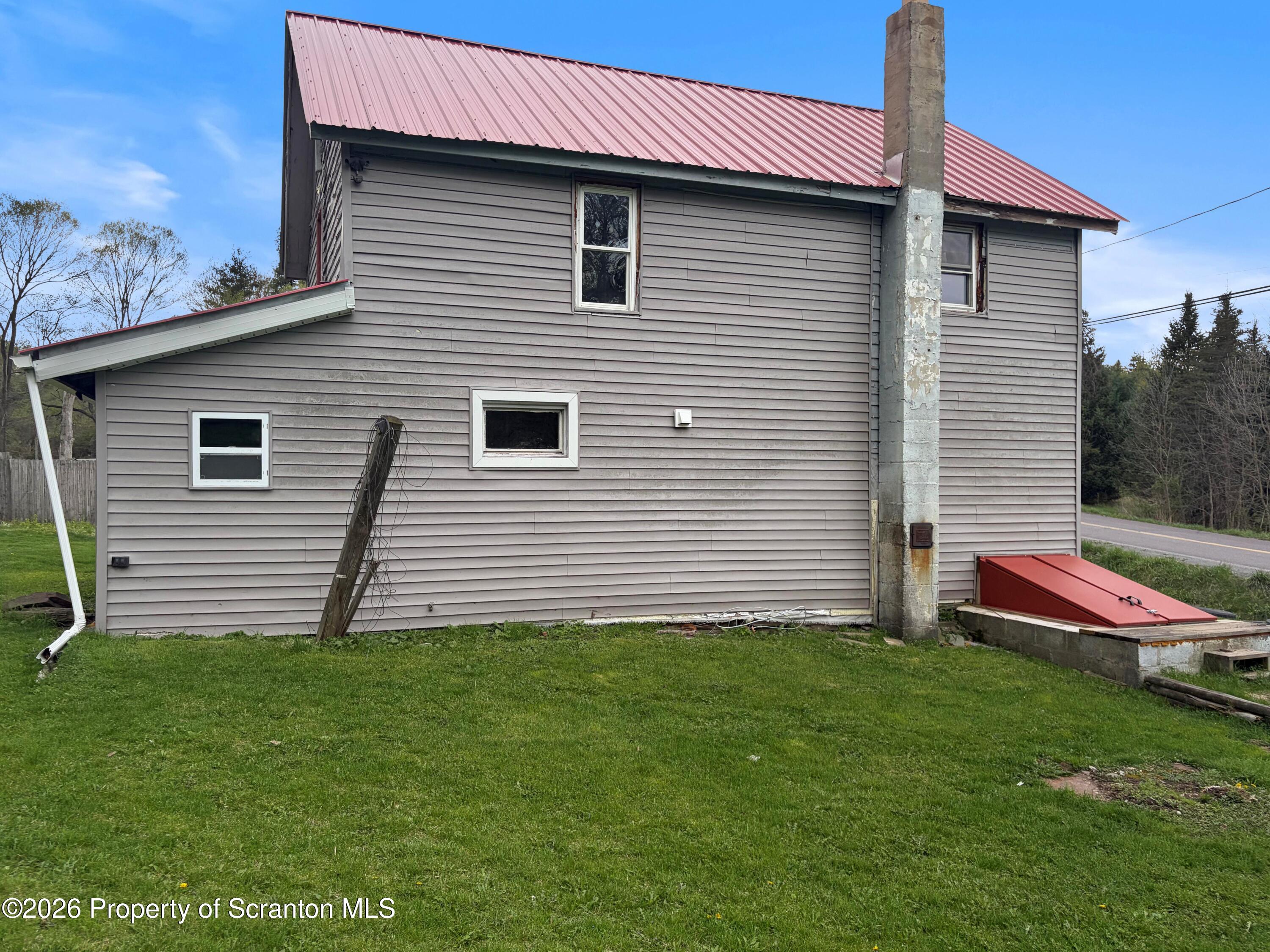 2466 State Rte 4002 Mehoopany, PA 18629 - Photo 2 of 11 a front view of a house with a garden