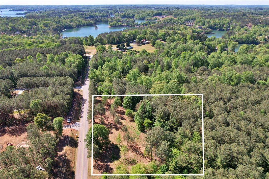 Lot 134 Mcalister Rd Union West Union, SC 29696 - Photo 37 of 43 This aerial view showcases a verdant lot nestled beside a serene lake, offering endless possibilities.