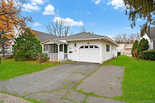 a front view of a house with a garden and yard