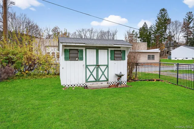 a view of a house with a yard and sitting area