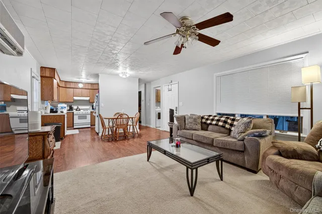 a living room with furniture and kitchen view