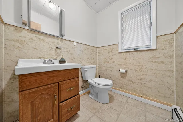 a bathroom with a sink toilet and mirror