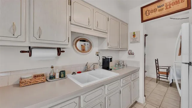 a kitchen with cabinets and window