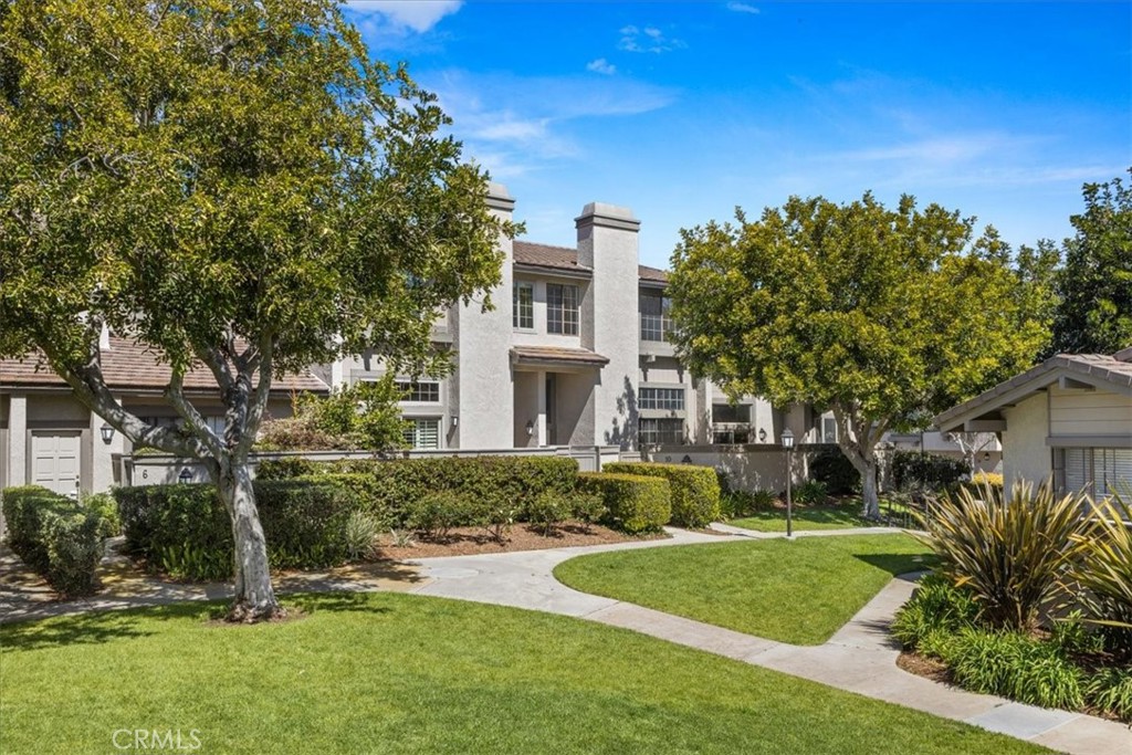 10 Sunshine, Unit 31 Irvine, CA 92603 - Photo 15 of 29 a front view of a house with a yard