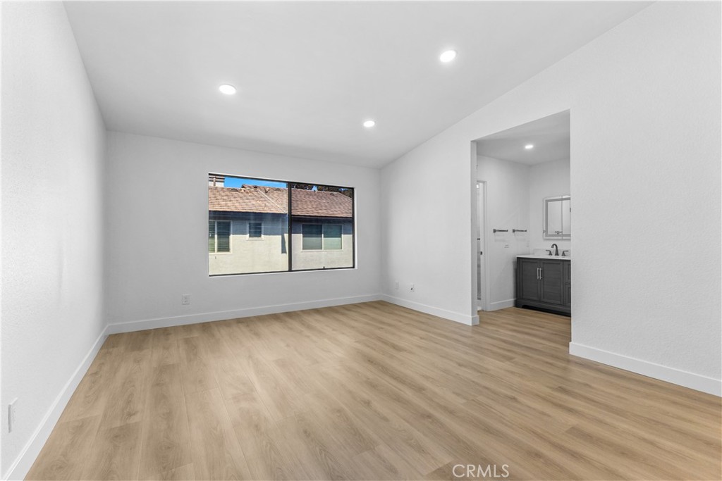 10 Sunshine, Unit 31 Irvine, CA 92603 - Photo 6 of 29 an empty room with wooden floor and windows