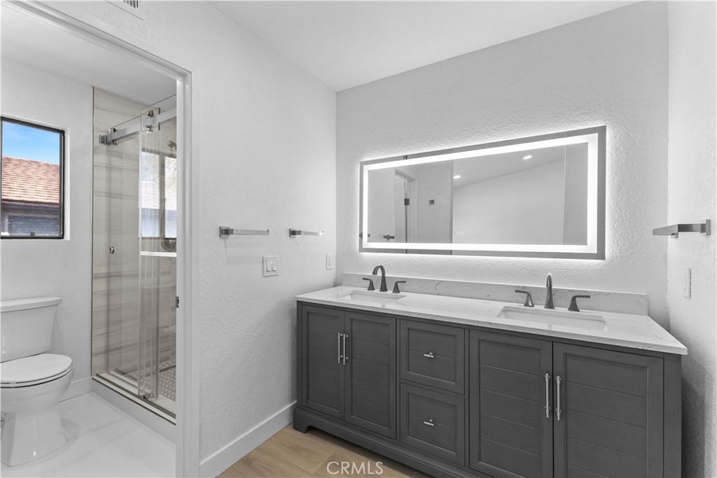 10 Sunshine, Unit 31 Irvine, CA 92603 - Photo 7 of 29 a bathroom with a toilet a sink a mirror and shower