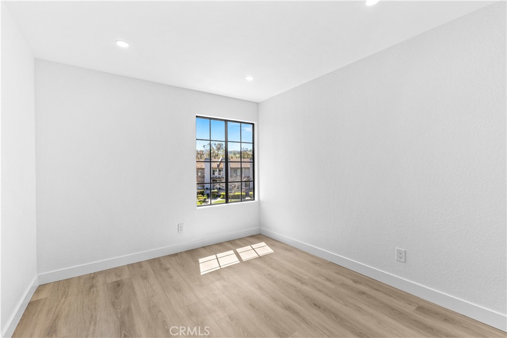 10 Sunshine, Unit 31 Irvine, CA 92603 - Photo 10 of 29 an empty room with wooden floor and windows