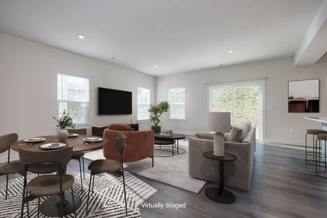 a living room with furniture a flat screen tv and a window