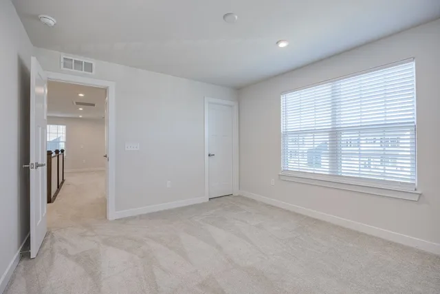 a bathroom with a bathtub shower sink mirror vanity and toilet