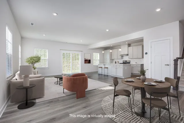 a living room with furniture and kitchen view