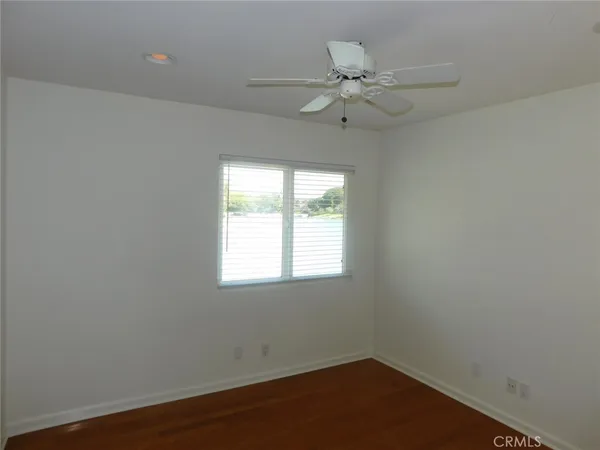 an empty room with windows and closet