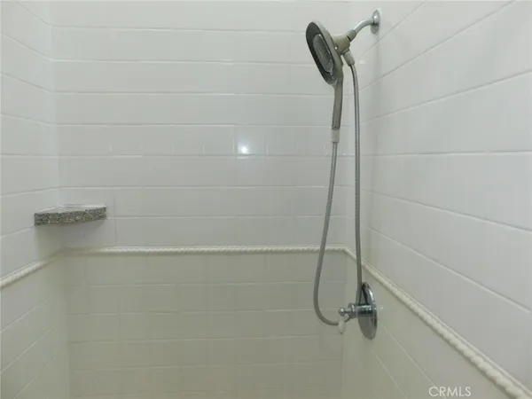 a white toilet sitting next to a shower