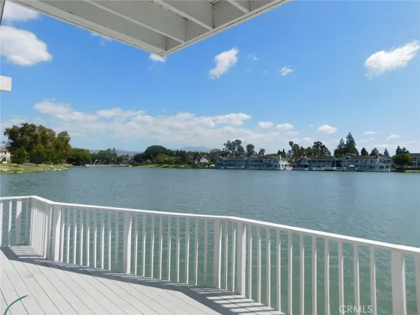 a view of balcony with wooden floor and lake view