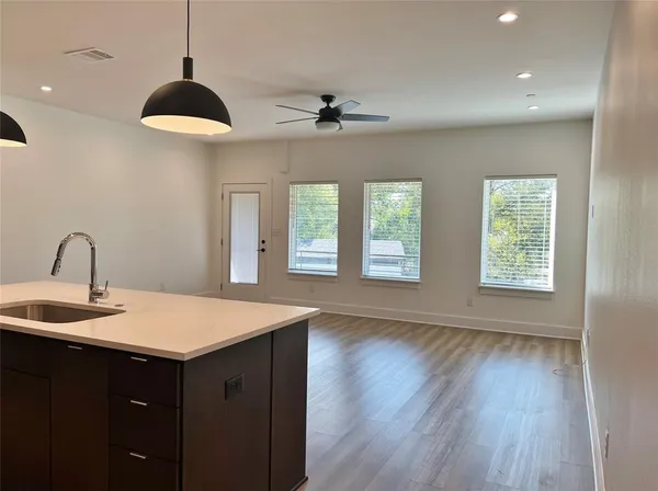 a kitchen with stainless steel appliances granite countertop a sink and a refrigerator