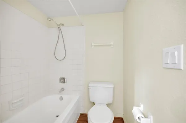 a bathroom with a toilet and a shower