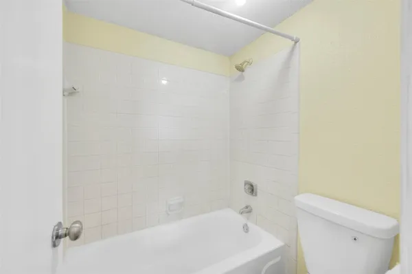 a bathroom with a bathtub and toilet