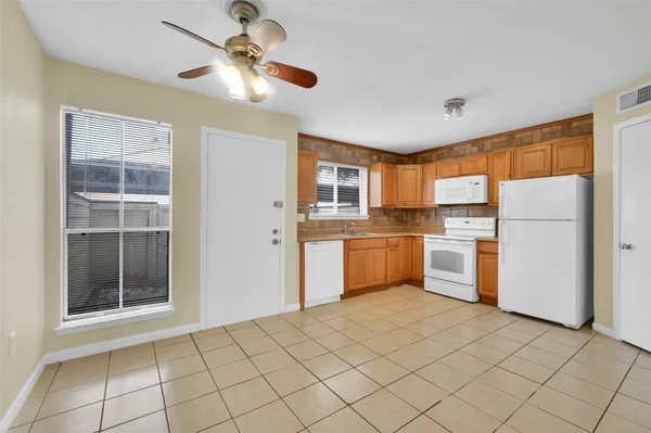 a kitchen with a refrigerator a sink and cabinets