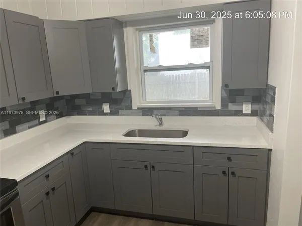 a bathroom with a sink and a window