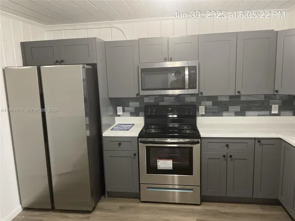 a kitchen with a stove microwave and refrigerator