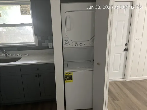 a close view of a utility room with dryer and washer
