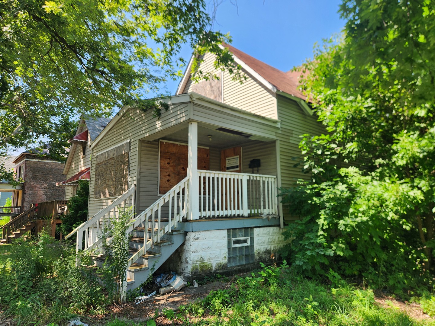 106 West 114th Street Chicago, IL 60628 - Photo 2 of 14 a front view of a house with a yard